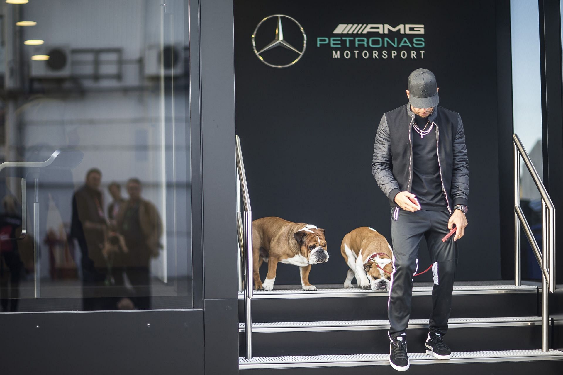 Lewis Hamilton leaves the motorhome with his dogs Roscoe and Coco in Budapest in July 2017. Source: Getty